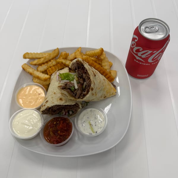 Savory meat wrap, crinkle-cut fries, four dipping sauces, and a Coca-Cola can on a white table.